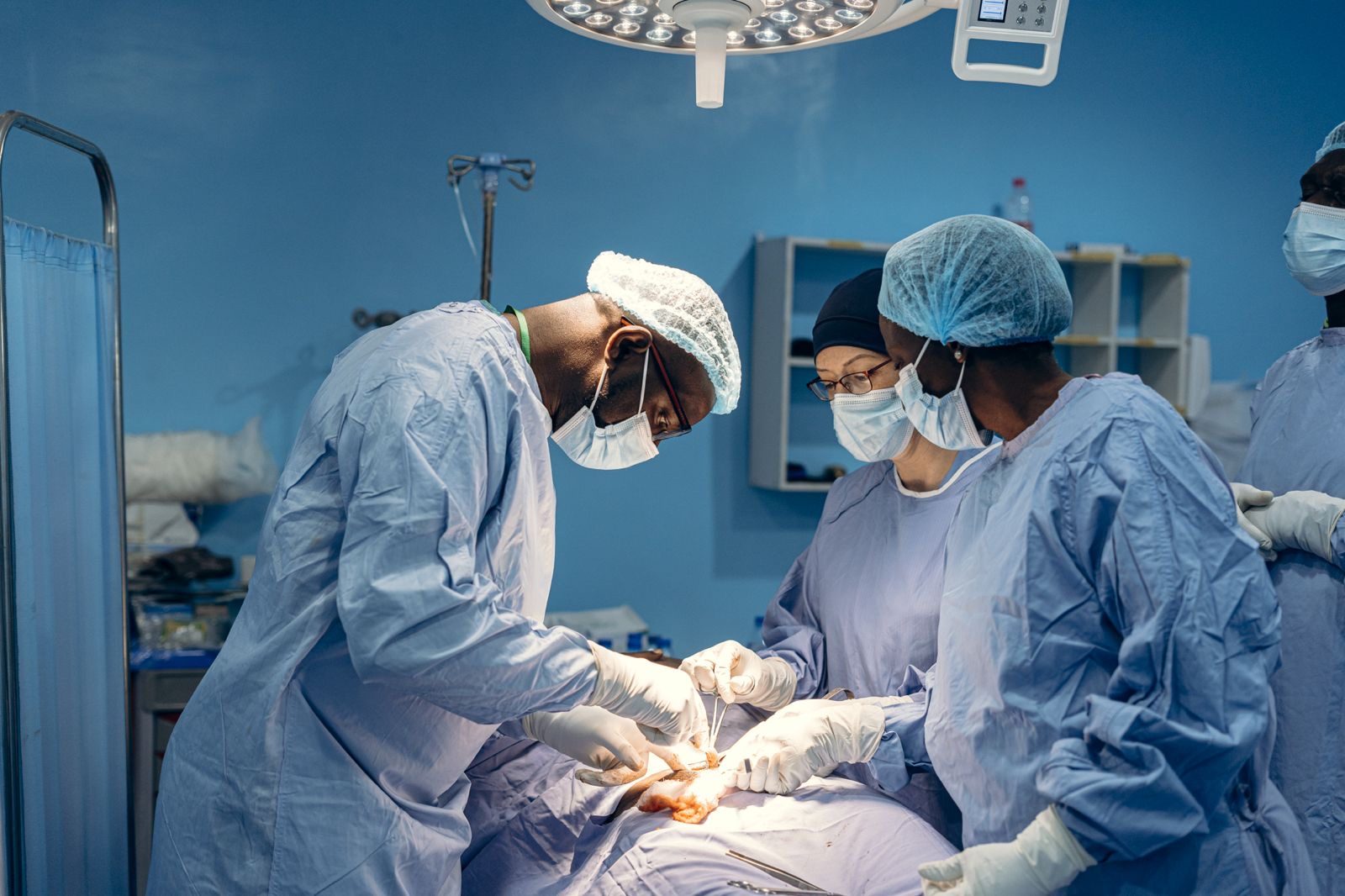 Dr. Adeboye leading a surgical team in the operating room